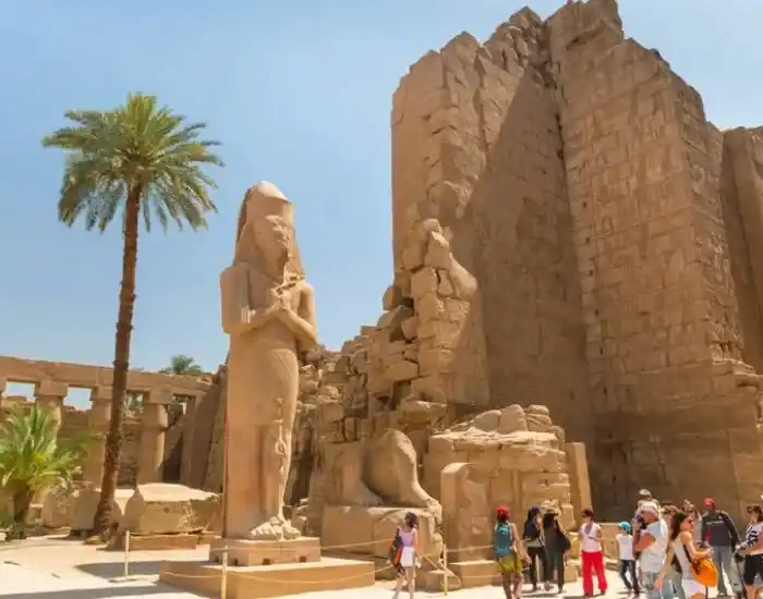Tourists-Exploring-Ancient-Statues-And-Ruins-In-Luxor-EgyptaTours