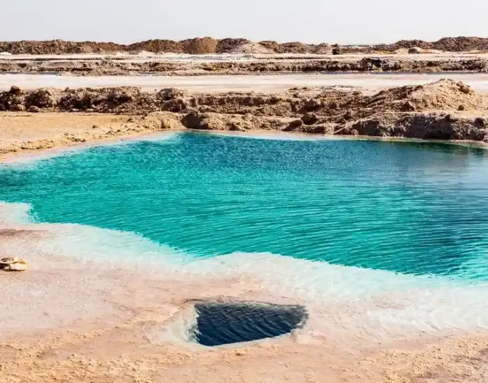 Bright-Turquoise-Salt-Pool-Surrounded-By-Salt-Formations-In-Siwa-Oasis-EgyptaTours