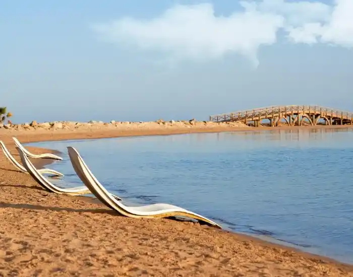 Sun-Loungers-On-A-Peaceful-Sandy-Beach-In-Soma-Bay-EgyptaTours