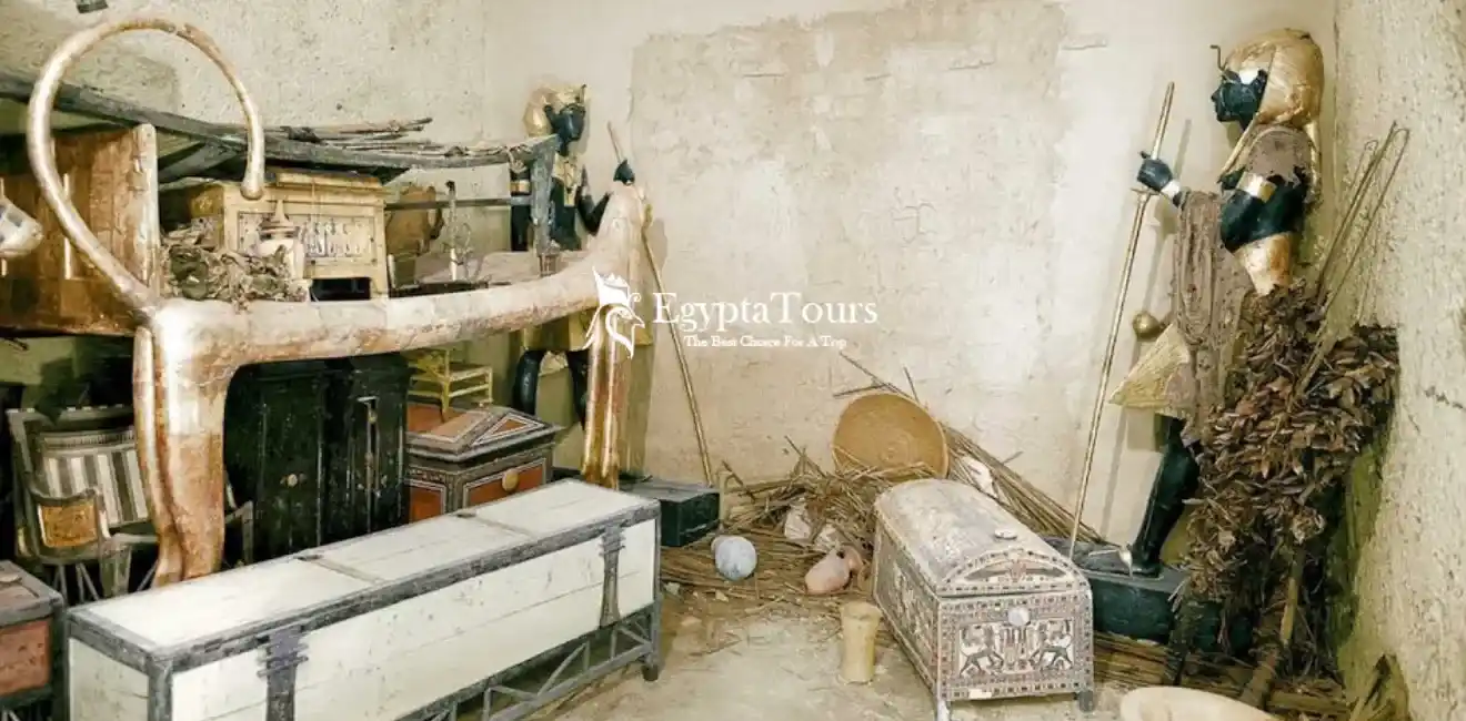 Inside-King-Tutankhamun's-tomb-showing-golden-chariots-statues-and-ancient-Egyptian-artifacts-EgyptaTours